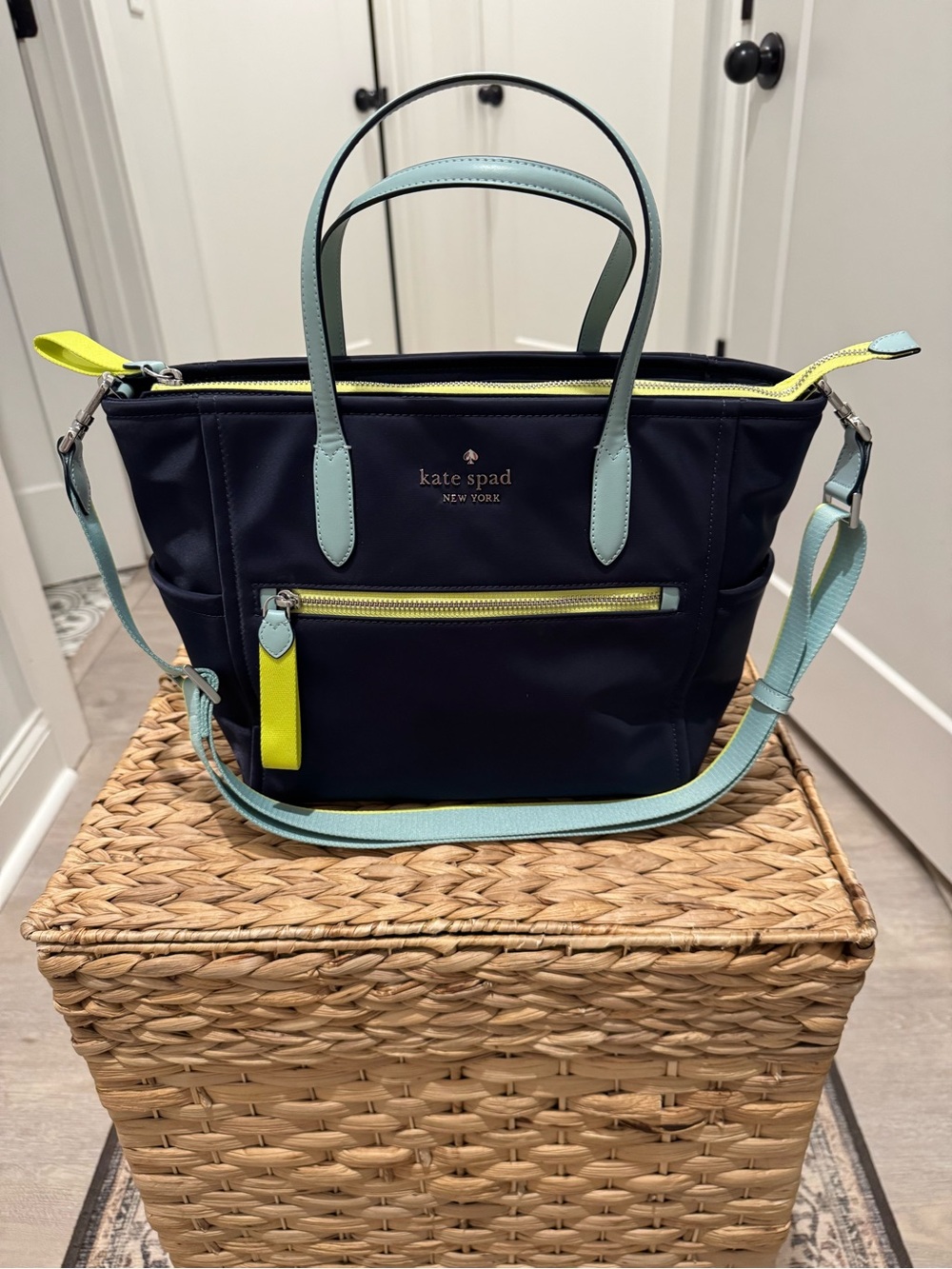 kate spade navy shoulder bag with light blue and yellow accents